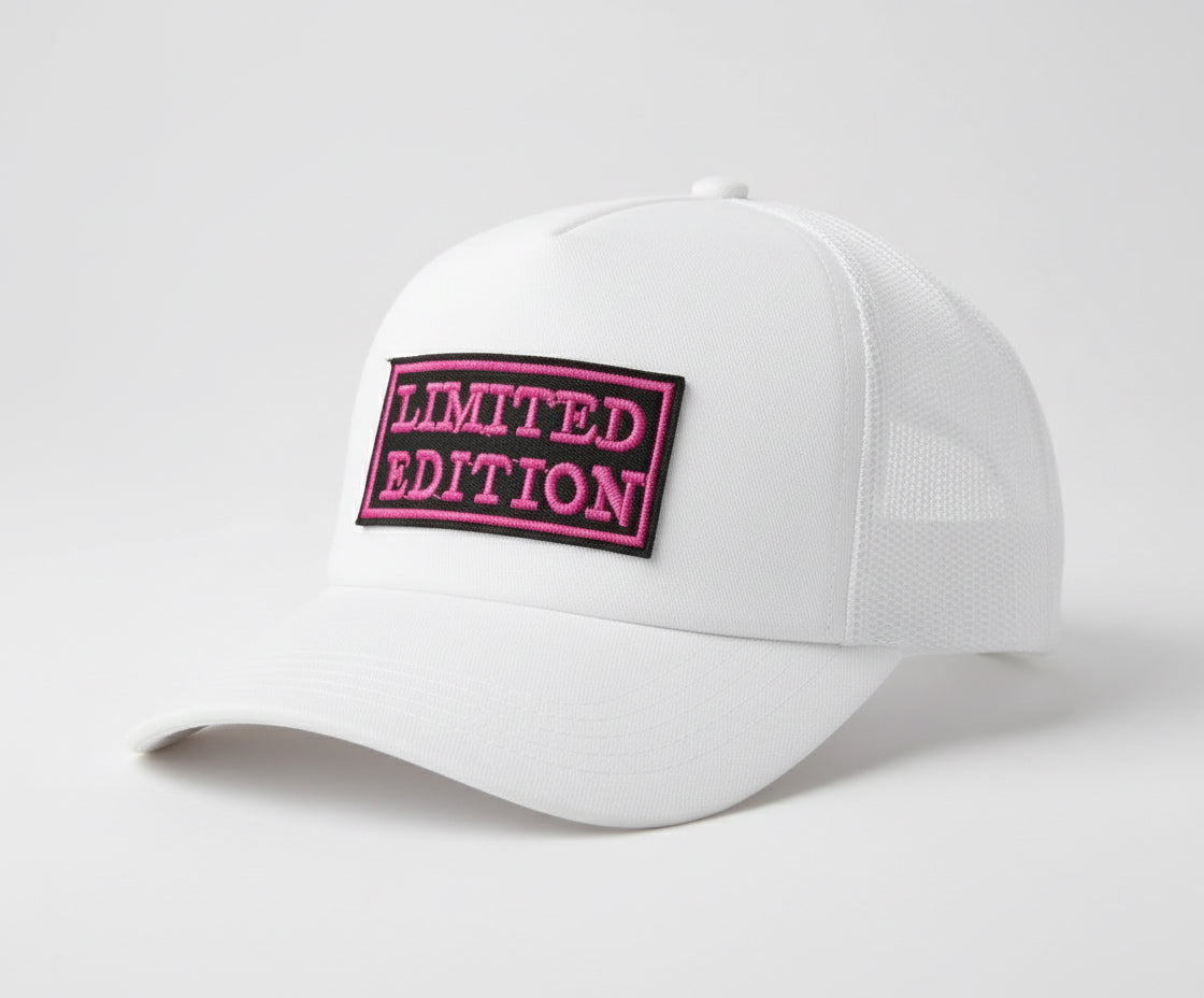 White cap with a pink 'LIMITED EDITION' patch on a light gray background