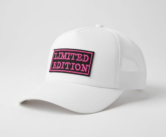 White cap with a pink 'LIMITED EDITION' patch on a light gray background